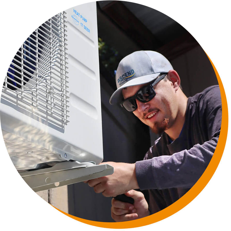 Ascend Air Solutions professional servicing an HVAC unit